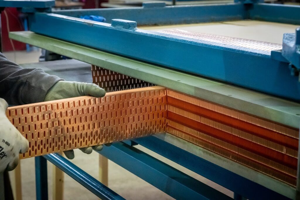 fins being loaded into an assembly fixture