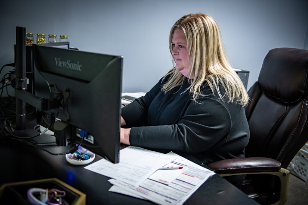 customer service rep typing on her computer at Active Radiator