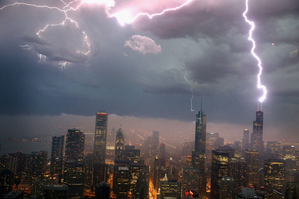 a city skyline with lightning striking