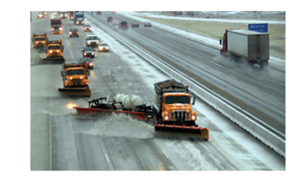 trucks plowing a highway