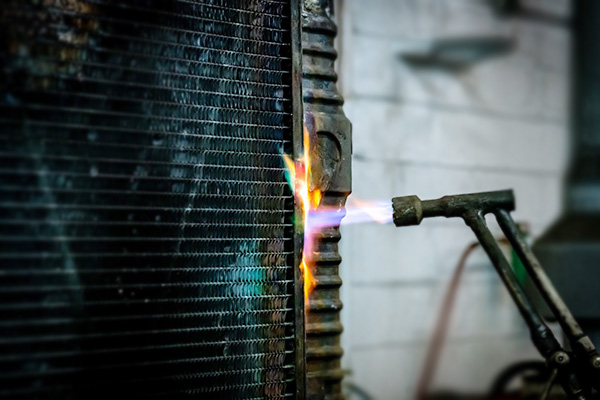 soldering a copper-brass radiator tank to the core