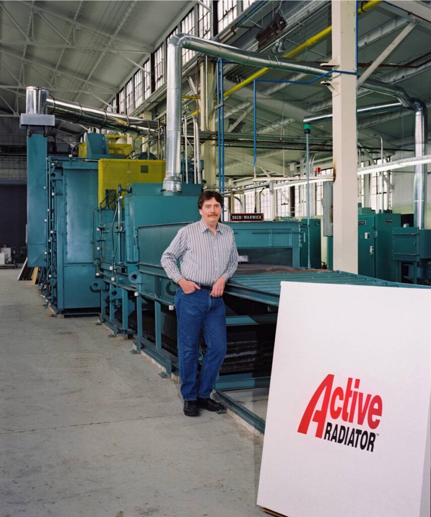 Marty Newell, founder of Active Radiator, next to his shop equipment